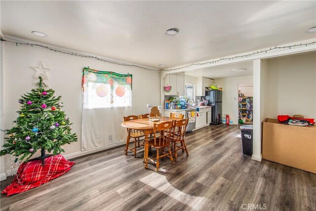 dining space featuring hardwood / wood-style flooring and sink