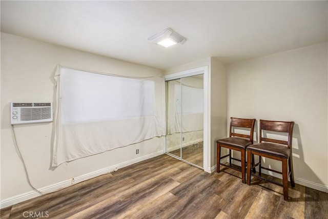 basement with dark hardwood / wood-style floors and a wall mounted air conditioner