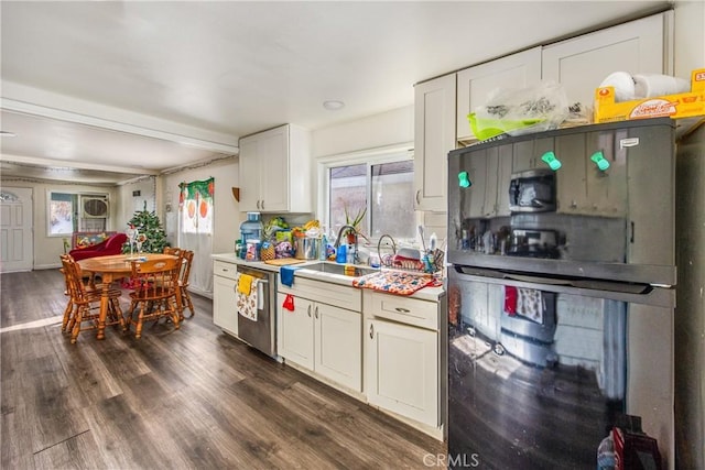 kitchen with white cabinets, dishwasher, black refrigerator, sink, and dark hardwood / wood-style floors