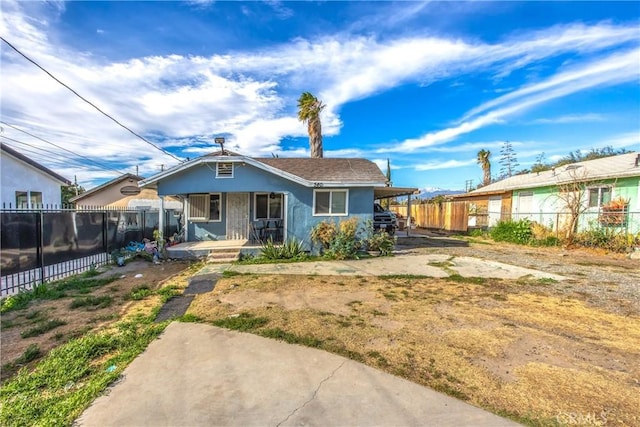 bungalow-style home with a porch and a carport