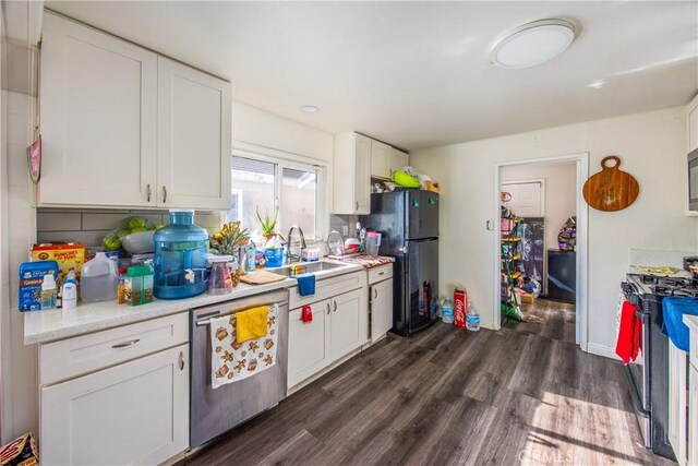 kitchen featuring sink, white cabinetry, and appliances with stainless steel finishes