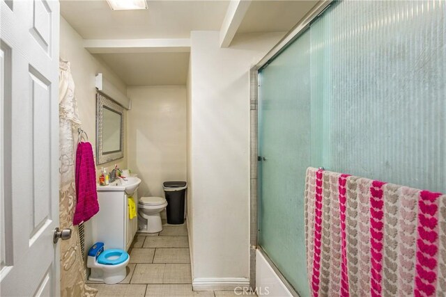 full bathroom with toilet, vanity, combined bath / shower with glass door, and tile patterned flooring