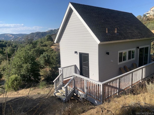 back of house featuring a deck with mountain view