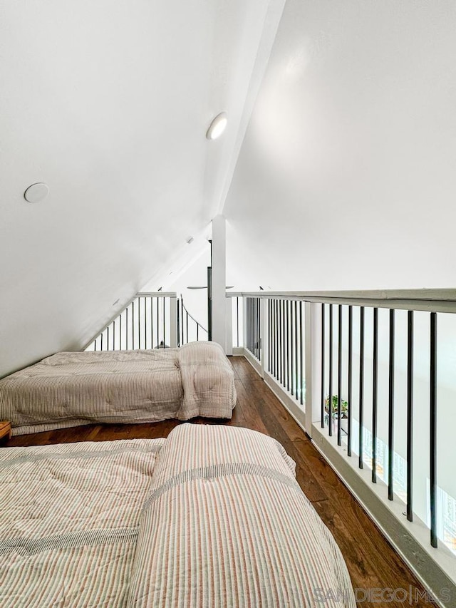 bedroom with dark hardwood / wood-style floors and vaulted ceiling