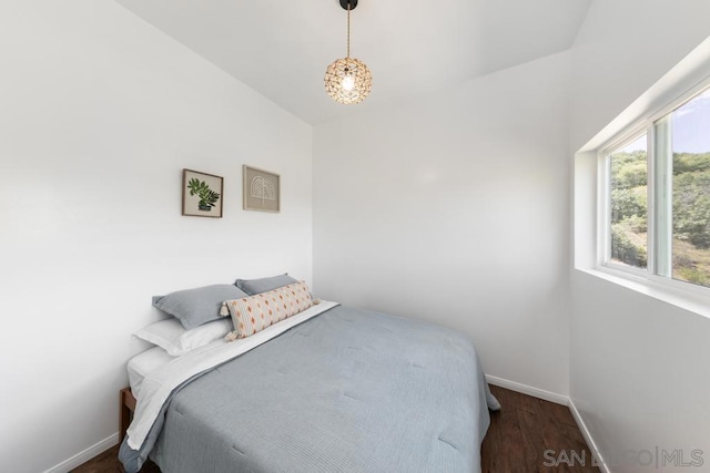 bedroom with dark hardwood / wood-style floors