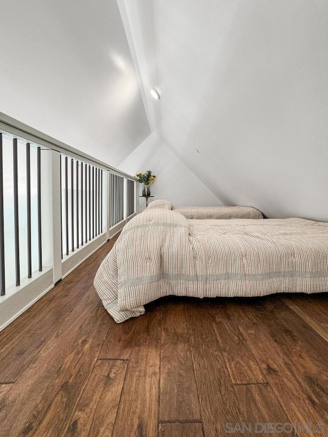 bedroom featuring vaulted ceiling and dark hardwood / wood-style flooring