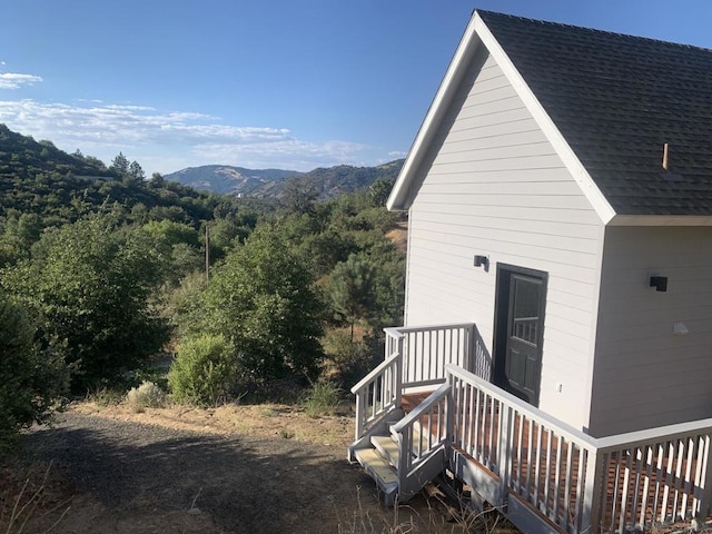 view of property exterior with a mountain view