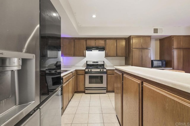 kitchen with light tile patterned floors and appliances with stainless steel finishes