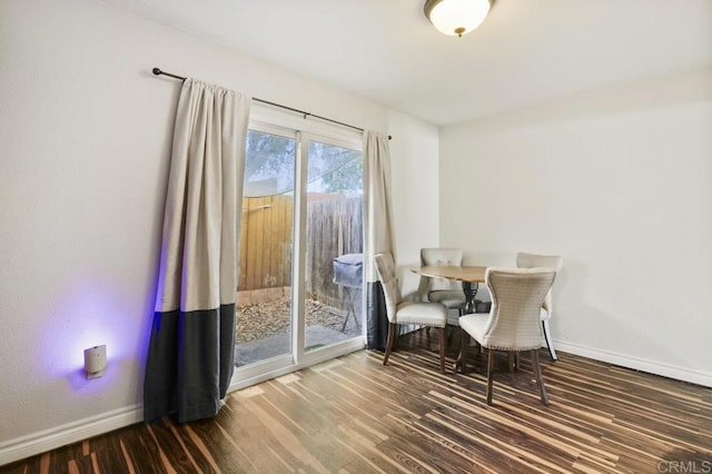 dining space featuring dark wood-type flooring