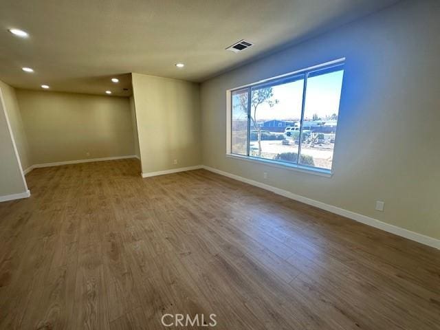 spare room featuring hardwood / wood-style floors