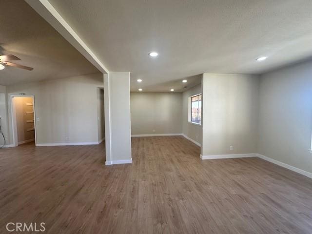 basement with ceiling fan and wood-type flooring