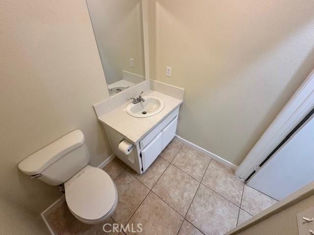 bathroom with tile patterned floors, vanity, and toilet