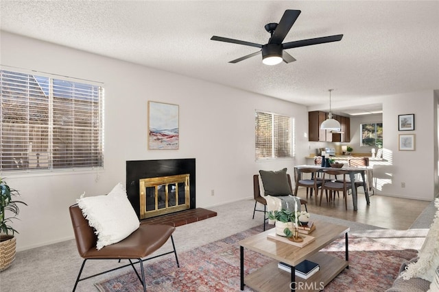 living room featuring a textured ceiling, ceiling fan, and light carpet