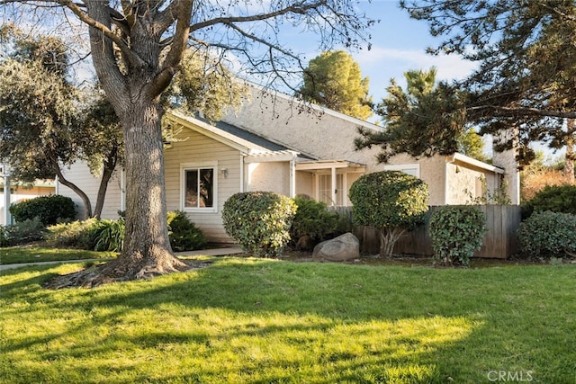 ranch-style home featuring a front yard