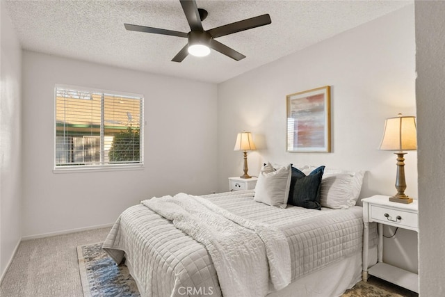 carpeted bedroom with a textured ceiling and ceiling fan