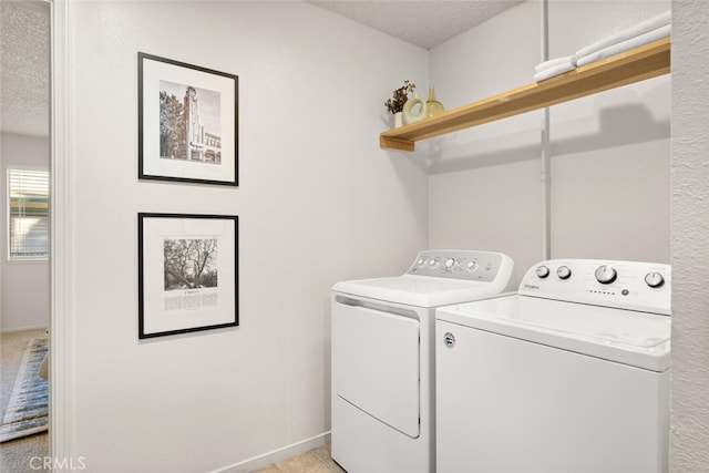 laundry room featuring separate washer and dryer and a textured ceiling