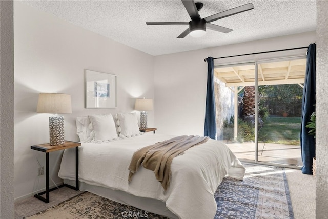 carpeted bedroom with a textured ceiling, access to outside, and ceiling fan