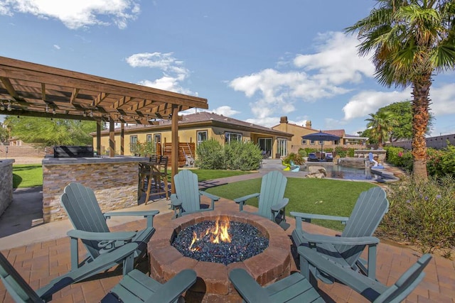 view of patio with a bar and an outdoor fire pit