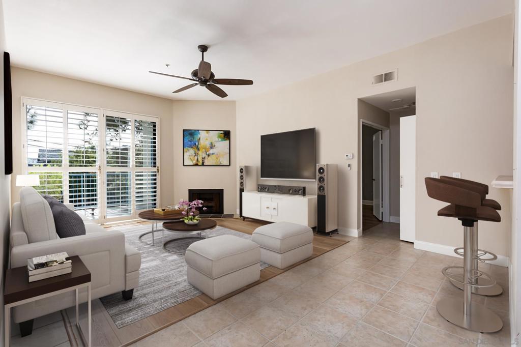 living room with ceiling fan, light tile patterned floors, and a fireplace