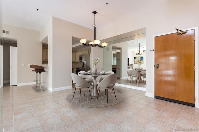 tiled dining space with an inviting chandelier