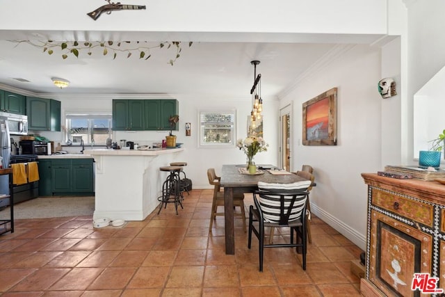 dining space featuring tile patterned floors and ornamental molding