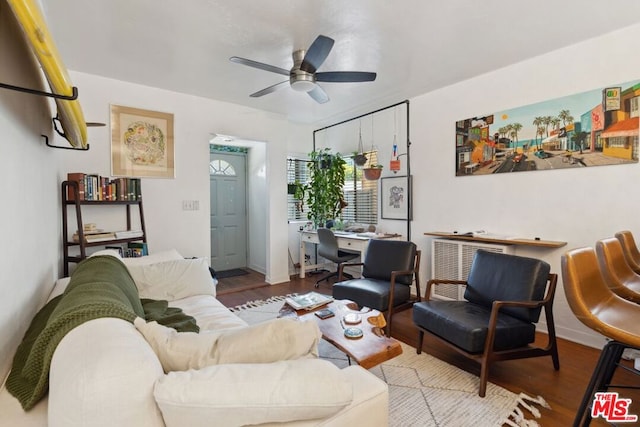 living room featuring ceiling fan and hardwood / wood-style flooring