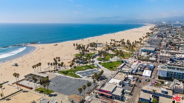 birds eye view of property featuring a beach view and a water view