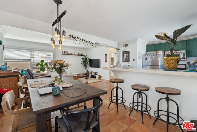 dining space featuring ornamental molding