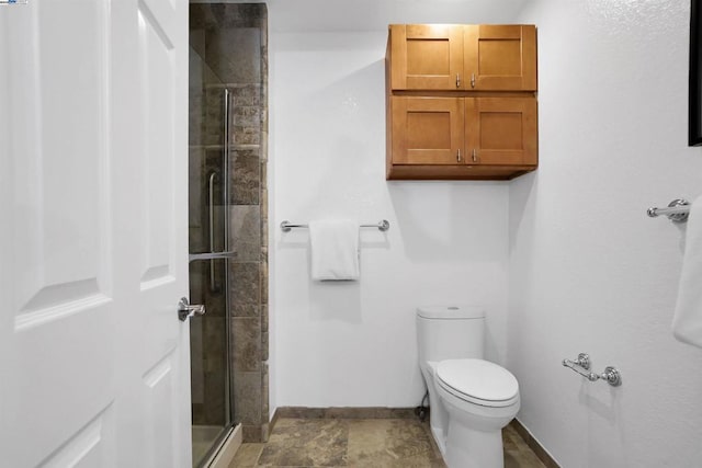 bathroom featuring an enclosed shower and toilet