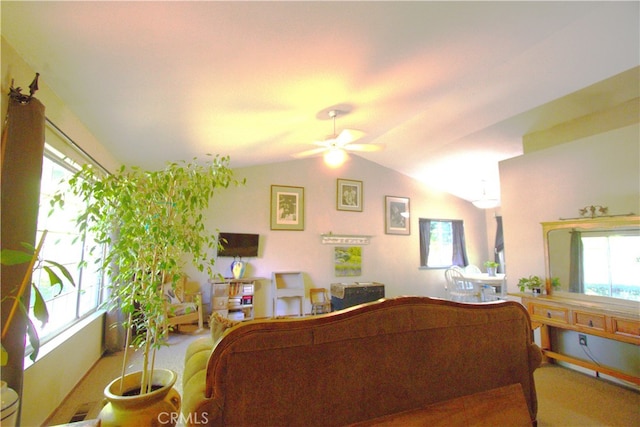 living room featuring ceiling fan, vaulted ceiling, and a wealth of natural light