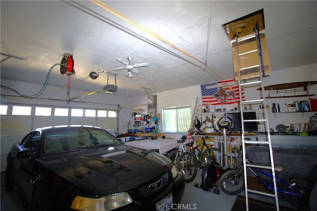 garage featuring a garage door opener and ceiling fan