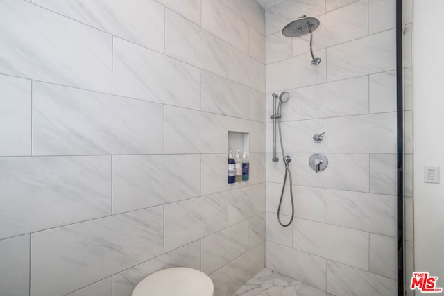 bathroom with tiled shower