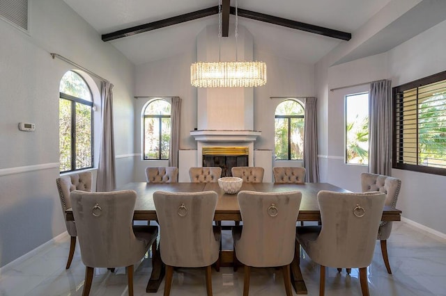 dining space featuring lofted ceiling with beams and an inviting chandelier