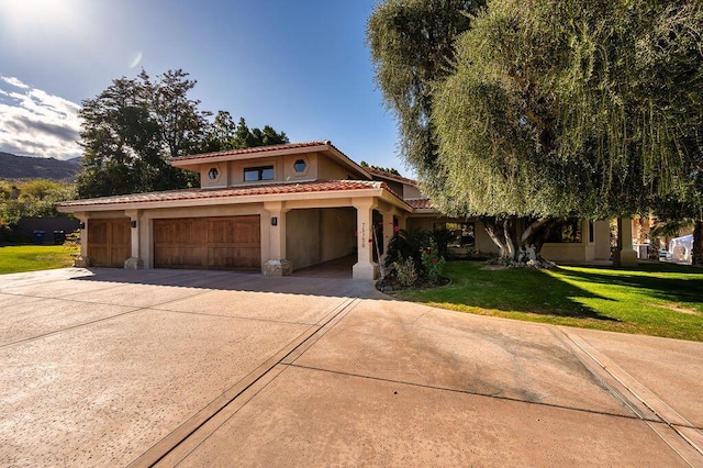 mediterranean / spanish home with a front lawn