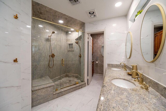 bathroom with a shower with shower door, tile walls, and vanity