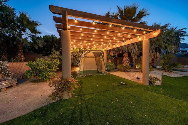 patio terrace at dusk with a pergola and a yard