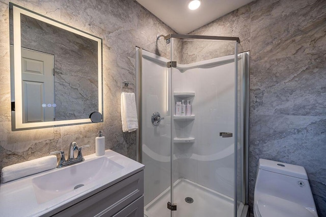 bathroom with toilet, vanity, and an enclosed shower