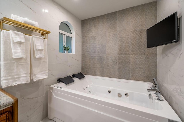 bathroom with tile walls and a bathtub