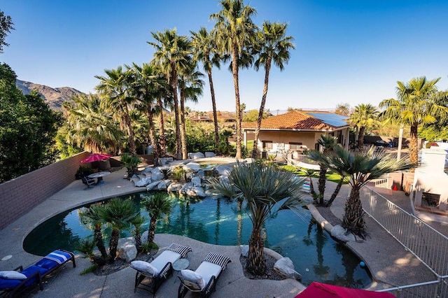 view of pool with a mountain view and a patio