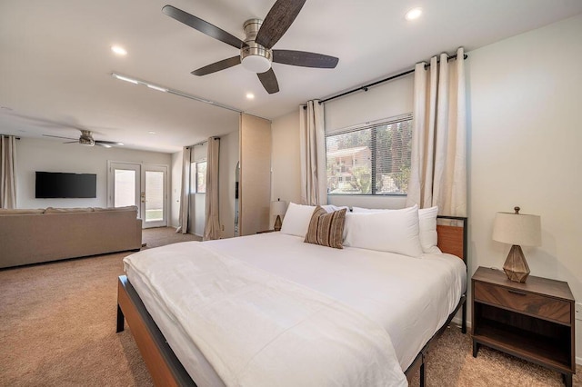 carpeted bedroom featuring ceiling fan and multiple windows