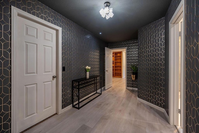 corridor with light hardwood / wood-style flooring