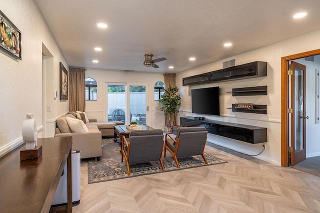 living room featuring ceiling fan and light parquet flooring