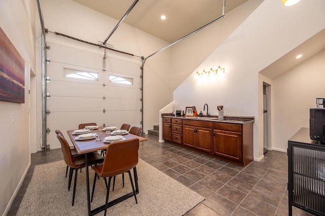 dining room featuring sink and dark tile patterned flooring