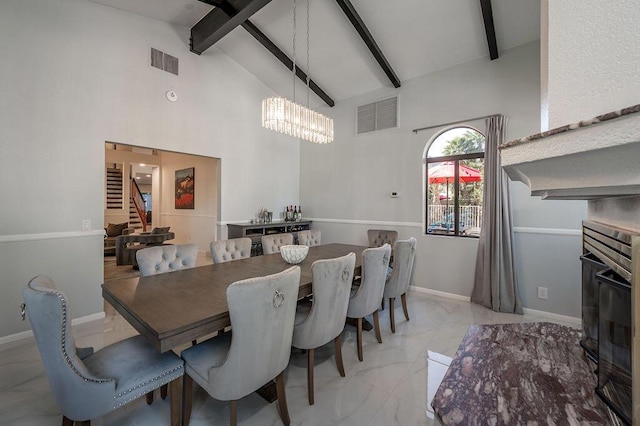 dining area featuring a chandelier, beam ceiling, and high vaulted ceiling