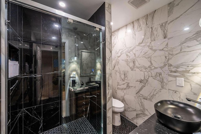 bathroom with toilet, tile walls, an enclosed shower, and sink