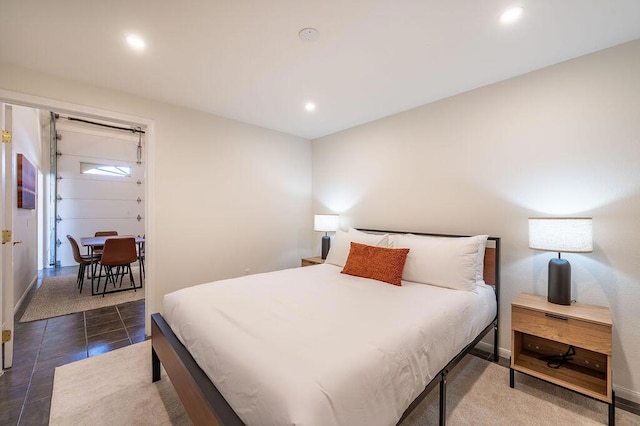 bedroom with dark tile patterned floors