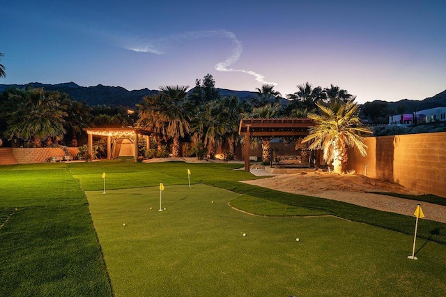 yard at dusk with a pergola and a mountain view