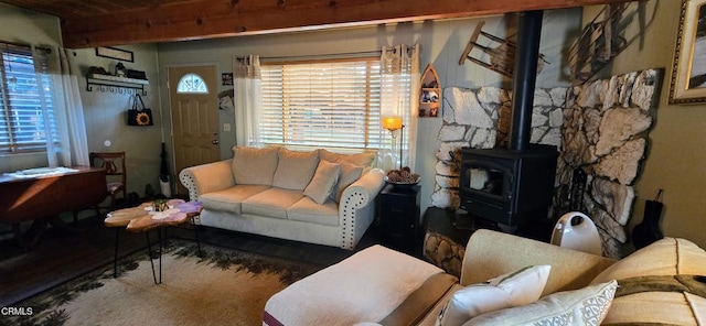 living room with beam ceiling and a wood stove