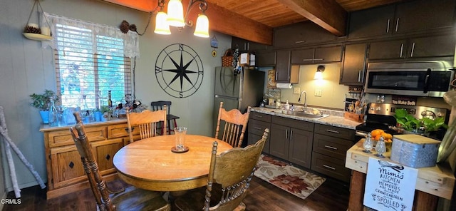 kitchen with stainless steel appliances, beamed ceiling, plenty of natural light, sink, and dark brown cabinets