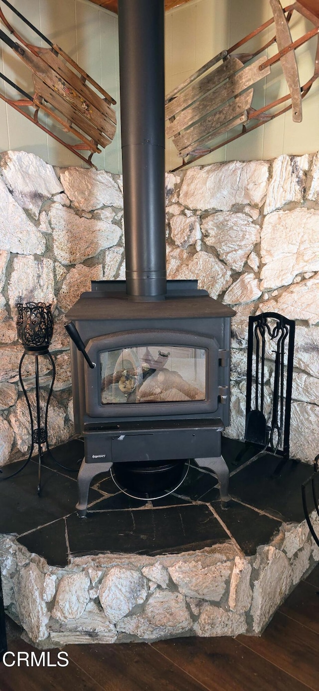 room details with wood-type flooring and a wood stove